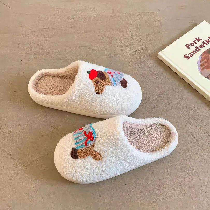 A pair of fuzzy white memory foam house shoes with a soft, comfortable feel, featuring a cute striped dachshund design, placed on a light brown floor.