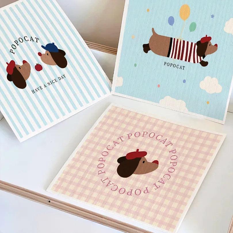 Dachshund-print cellulose towels expand with water and harden when dry, reusable for multiple cleaning cycles.