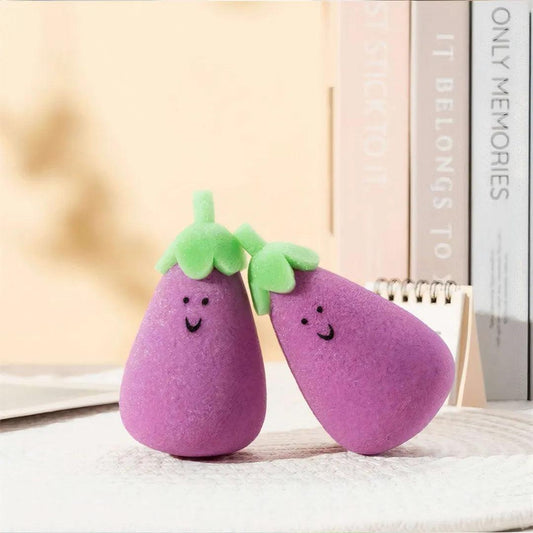 Standing purple eggplant sponges with green leaves and smiling faces beside pastel books.