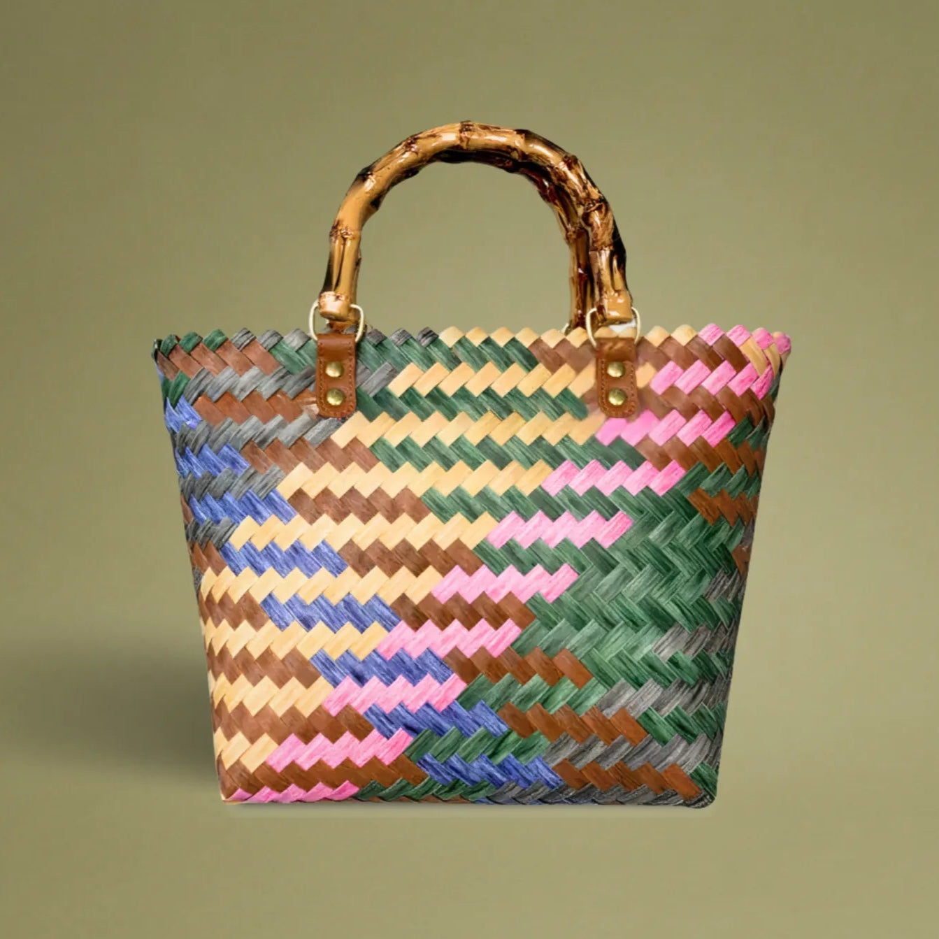 Handwoven bamboo tote with colorful diagonal striped pattern, crafted with care from recycled plastic, featuring a vintage, artisanal look.
