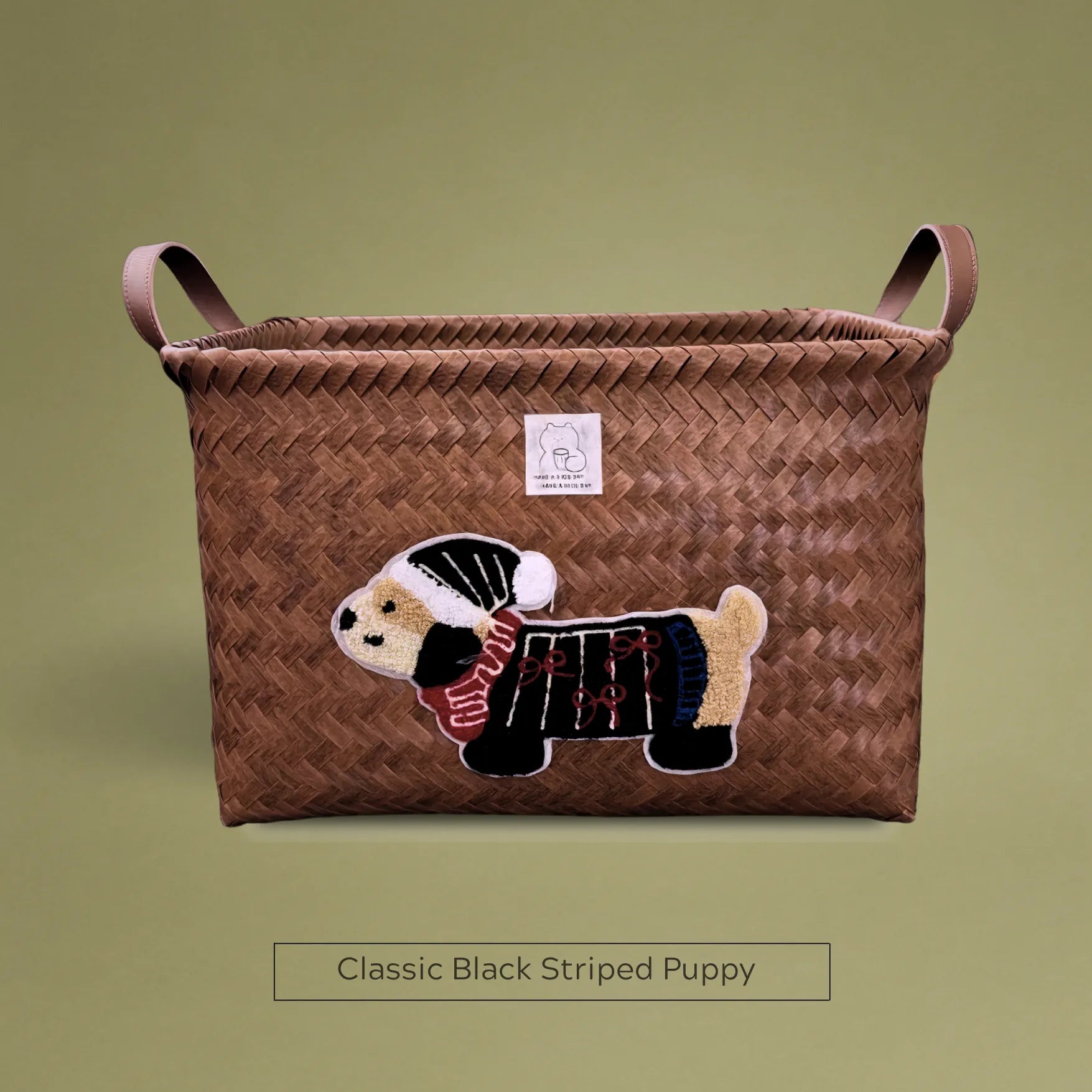Handwoven wicker storage basket with classic black striped puppy embroidery, perfect for chic home organization