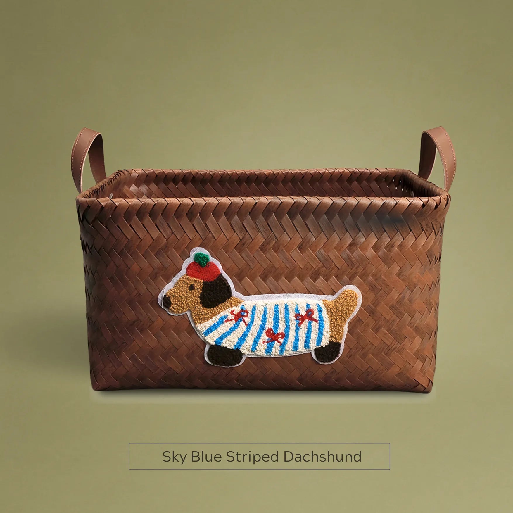 Handwoven wicker storage basket with sky blue striped dachshund embroidery, perfect for chic home storage and décor