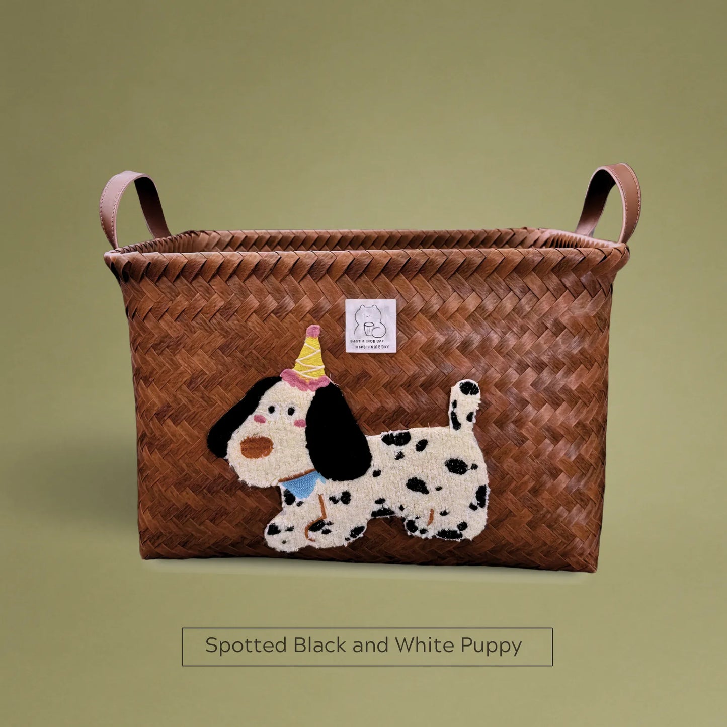 Handwoven wicker storage basket with spotted black and white puppy embroidery, ideal for stylish home storage