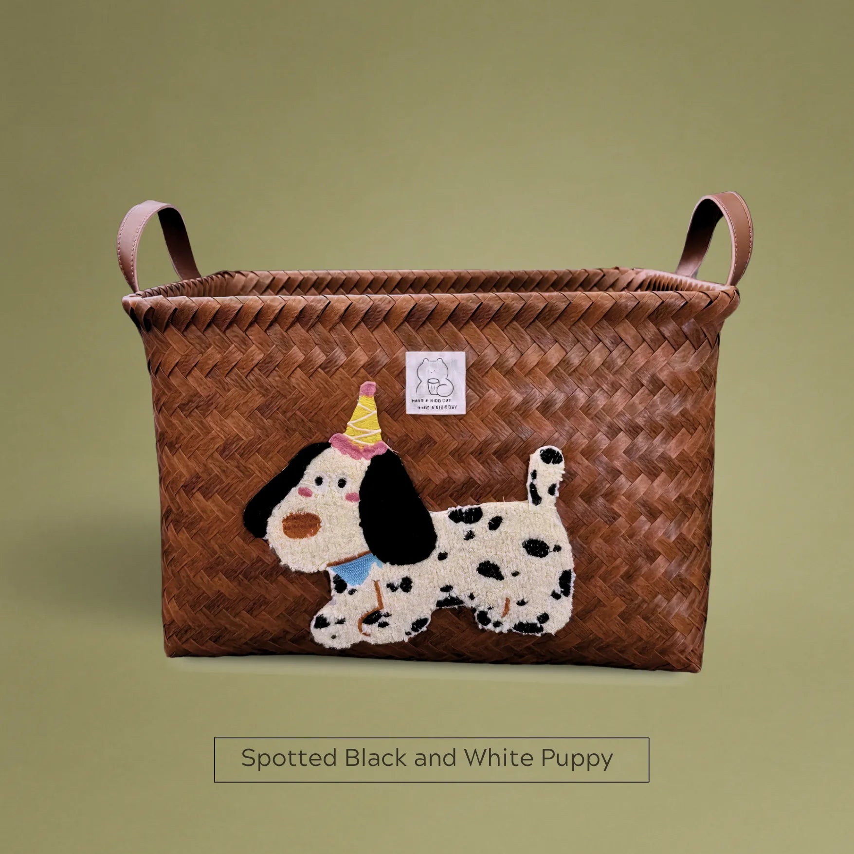 Handwoven wicker storage basket with spotted black and white puppy embroidery, ideal for stylish home storage