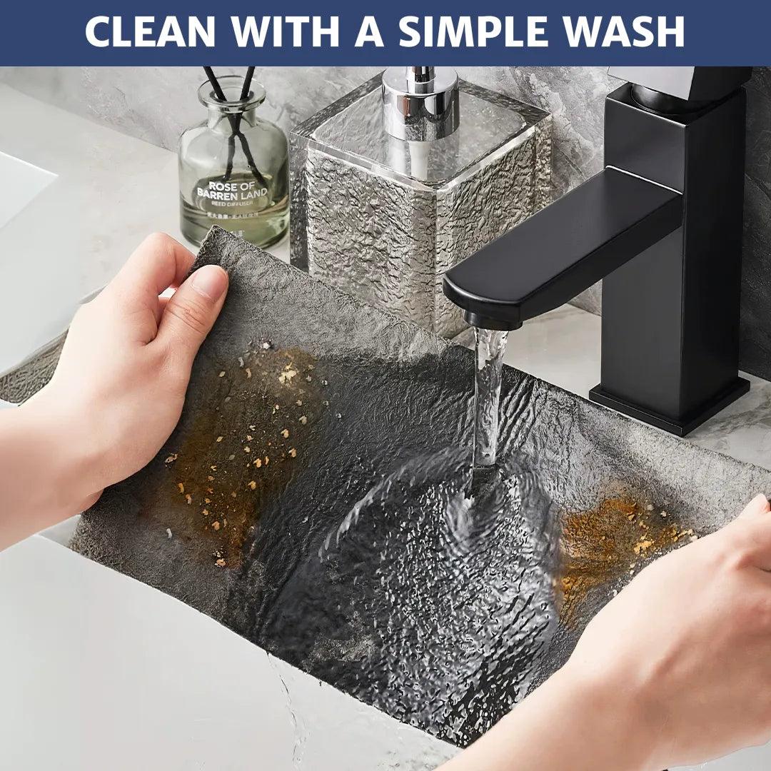 Microfiber cloth with visible dirt being rinsed under clean water, instantly removing stains and showing how easy it is to clean and maintain for long-lasting use.