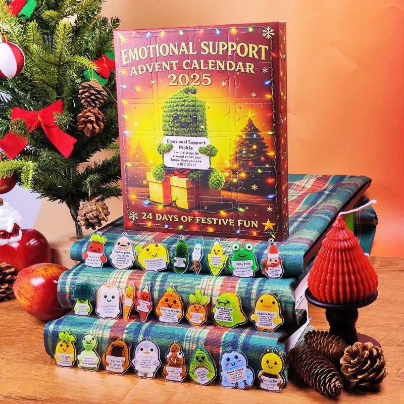 Emotional Support Advent Calendar 2025 with small figures on a wooden surface with Christmas decorations.