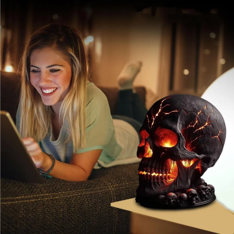 Woman relaxing on couch with Halloween skull lava lamp emitting warm red-orange glow.