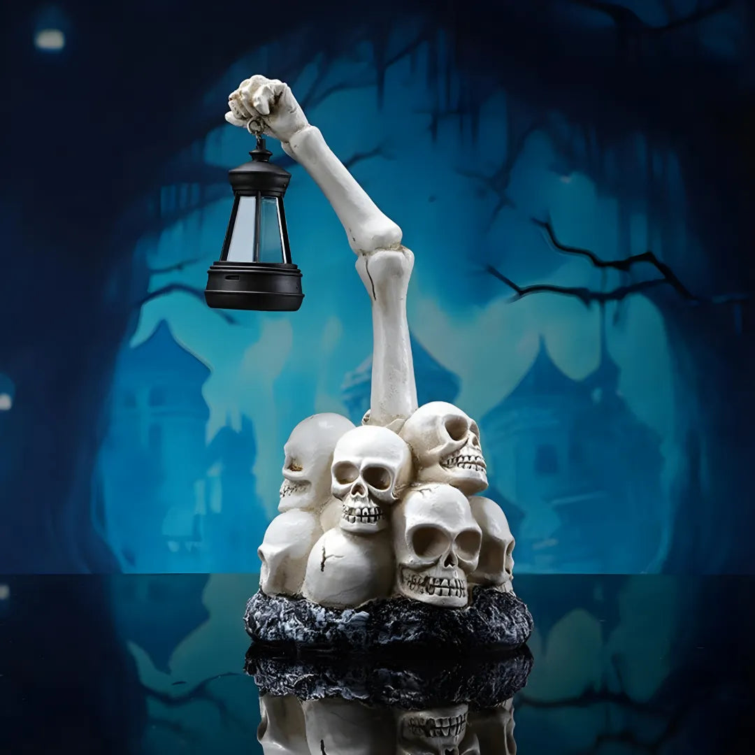 Statue of a skeleton hand holding a lantern over skulls with a spooky background