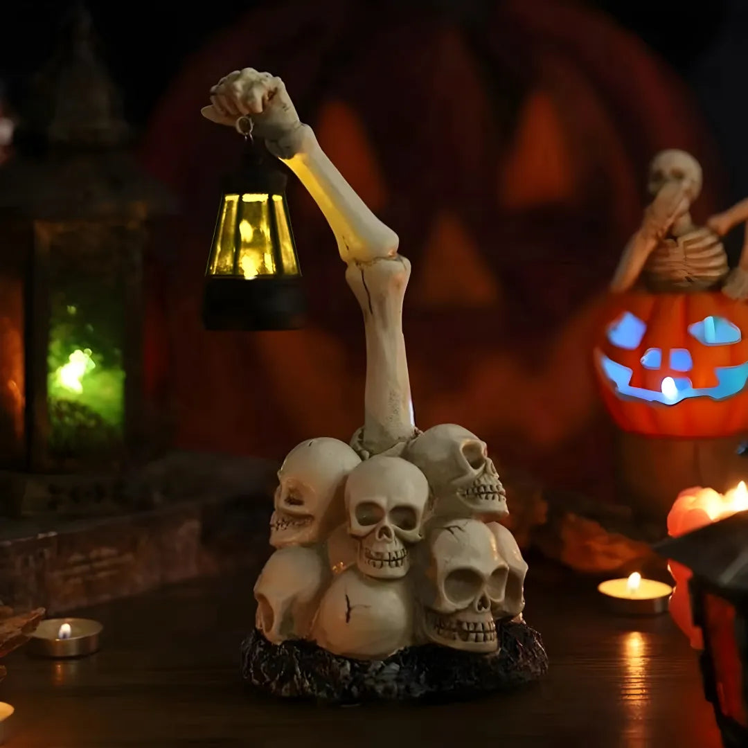 Skeleton hand holding a lantern over skulls with Halloween decorations in the background