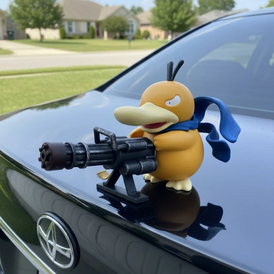 Psyduck car ornament with playful new look: yellow character in blue scarf aiming machine gun on black car hood against suburban neighborhood backdrop.