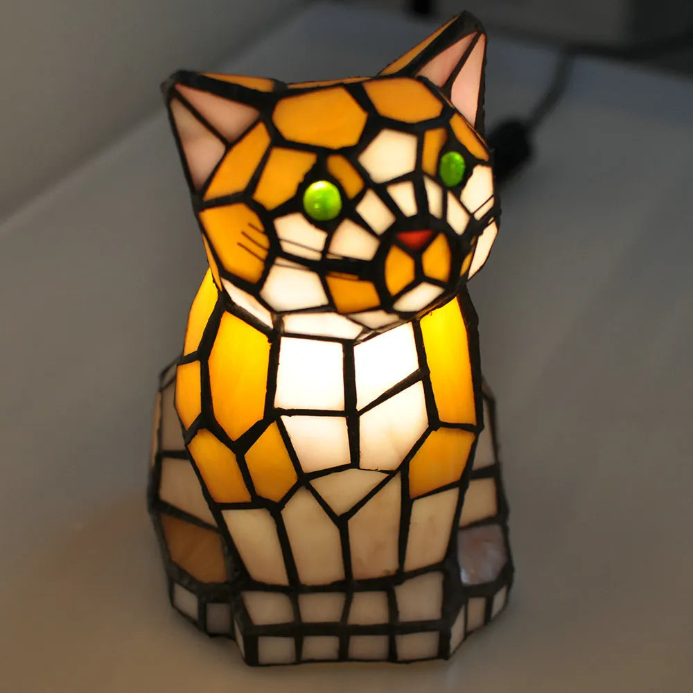 Stained glass cat-shaped lamp on a plain background