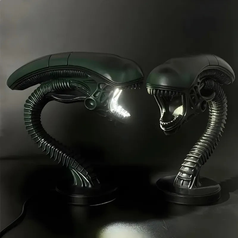 Two alien lamp sculptures with ribbed heads and tentacle-like appendages on a dark background.
