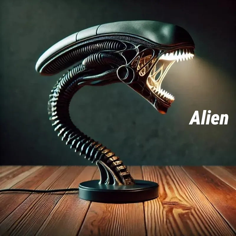 Xenomorph alien desk lamp with glowing open mouth and segmented neck. Dark sci-fi decor placed on wooden surface, perfect for collectors and gaming setups.