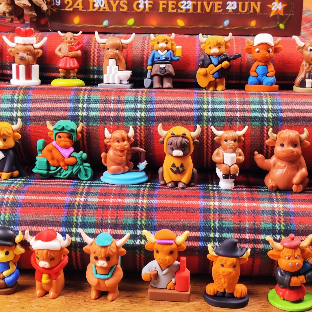 Collection of small figurines with bull designs on a plaid fabric background