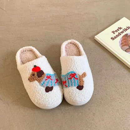 A pair of fuzzy white memory foam house shoes featuring a cute and creative dachshund design with blue stripes and red bows, placed on a light brown floor.