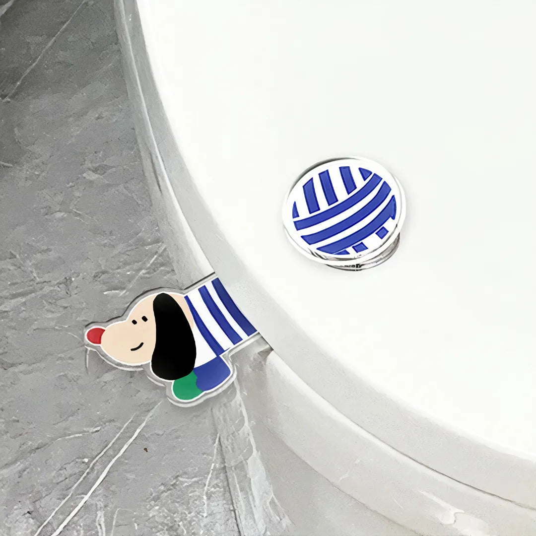 A cute and creative dachshund-shaped acrylic toilet seat lifter with blue stripes, attached to a white toilet seat, next to a blue striped button sticker.