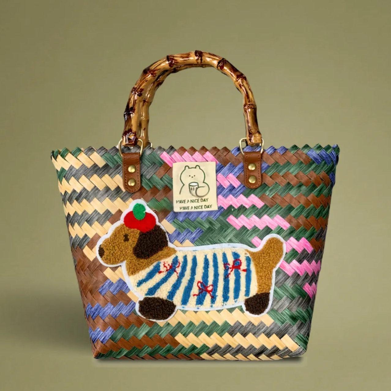 Handwoven bamboo tote with colorful dachshund embroidery, crafted from recycled plastic for a playful yet vintage-inspired look.