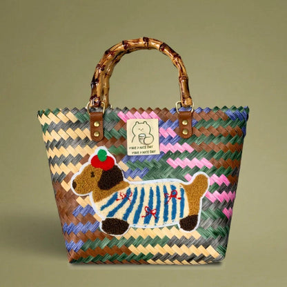 Handwoven bamboo tote with colorful dachshund embroidery, crafted from recycled plastic for a playful yet vintage-inspired look.