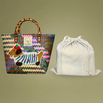 Handwoven bamboo tote with dachshund embroidery, featuring a sturdy bamboo handle and a complimentary canvas drawstring bag for security