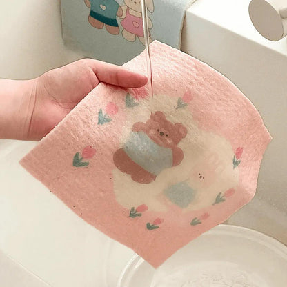 Bear-print cellulose towel expanding and softening under running water.