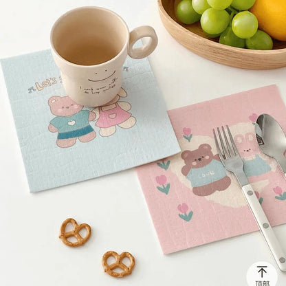 Bear-print cellulose towels used as placemats or kitchen cleaning cloths.