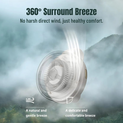 White translucent clip-on mini fan emitting three curved airflow streams, labeled "360° Surround Breeze" and "No harsh direct wind" against misty mountain backdrop, promoting natural gentle cooling.