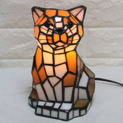 Mosaic cat-shaped lamp with warm colors on a white background