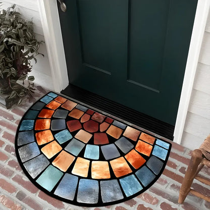 Colorful mosaic doormat in front of a dark green door on a brick floor.