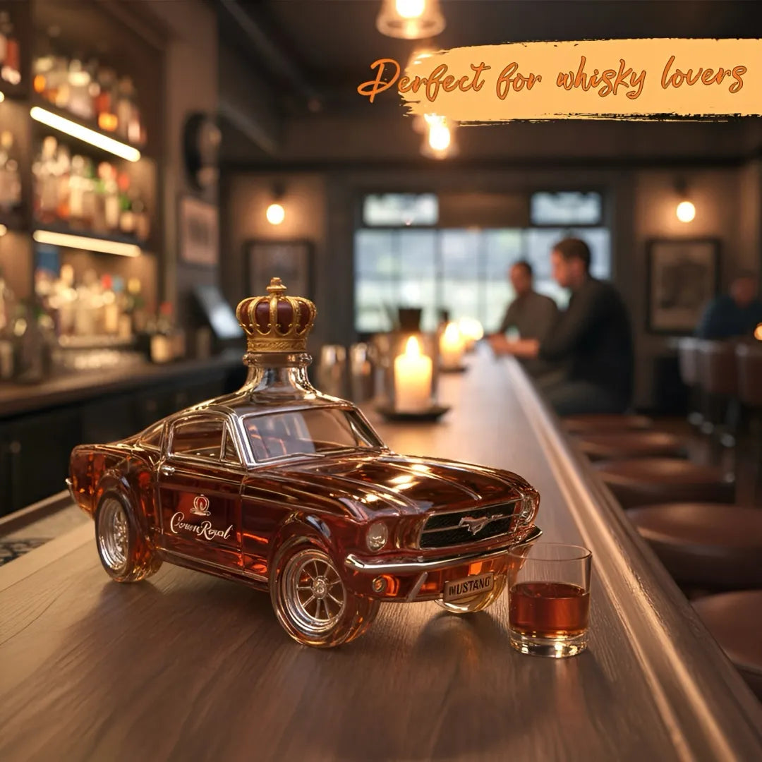 Car-shaped whiskey bottle on a bar with a glass of whiskey, surrounded by a bar setting.