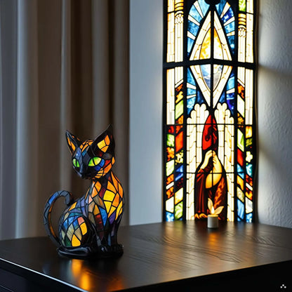 Stained glass cat sculpture in front of a stained glass window