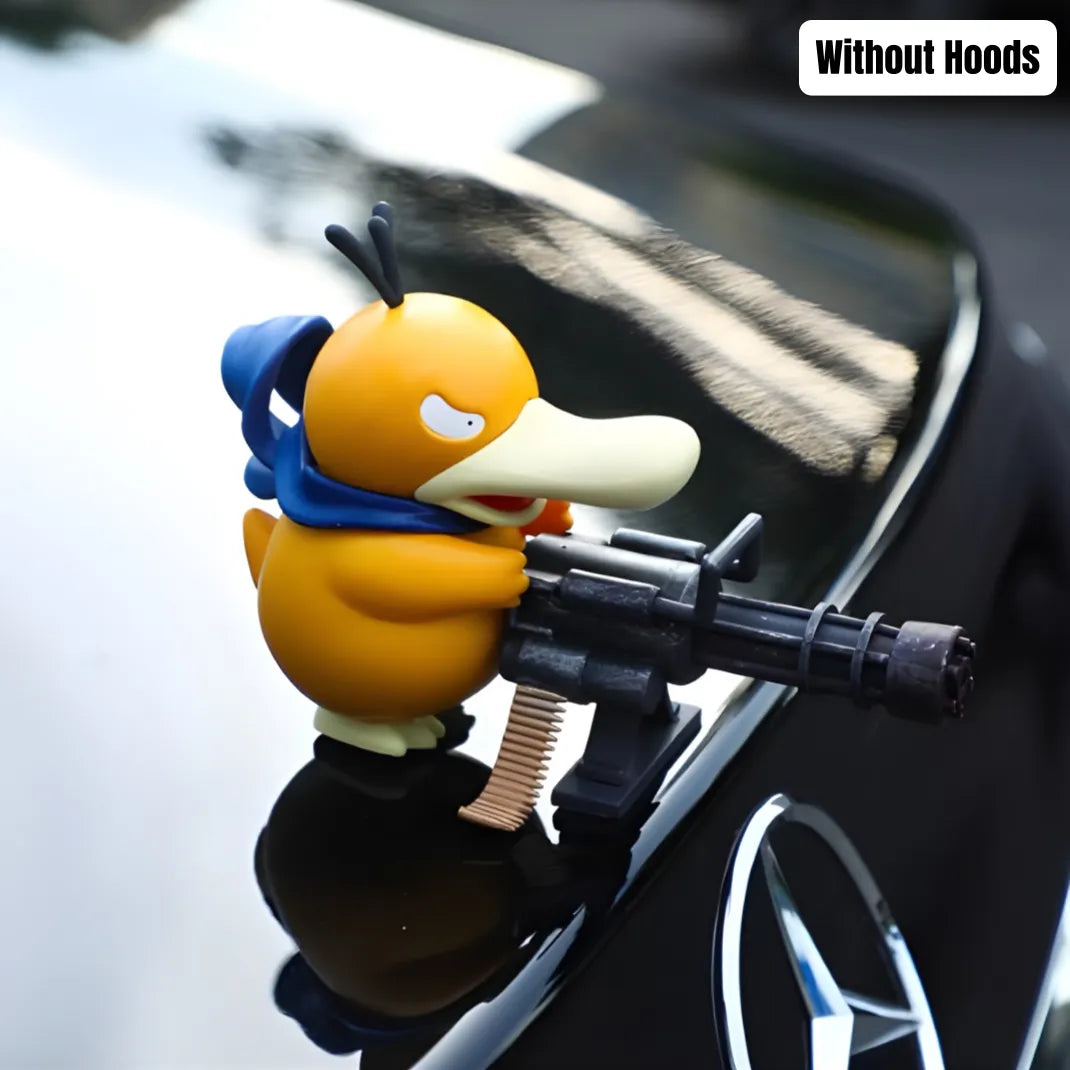 Psyduck car ornament without hoods wears blue cape and holds toy machine-gun on glossy black car surface with "Without Hoods" text visible.