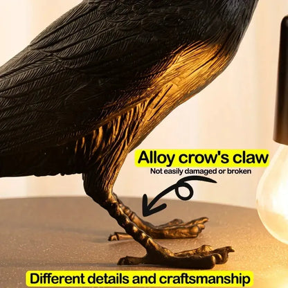 Metallic crow sculpture with highlighted alloy claw on a neutral background