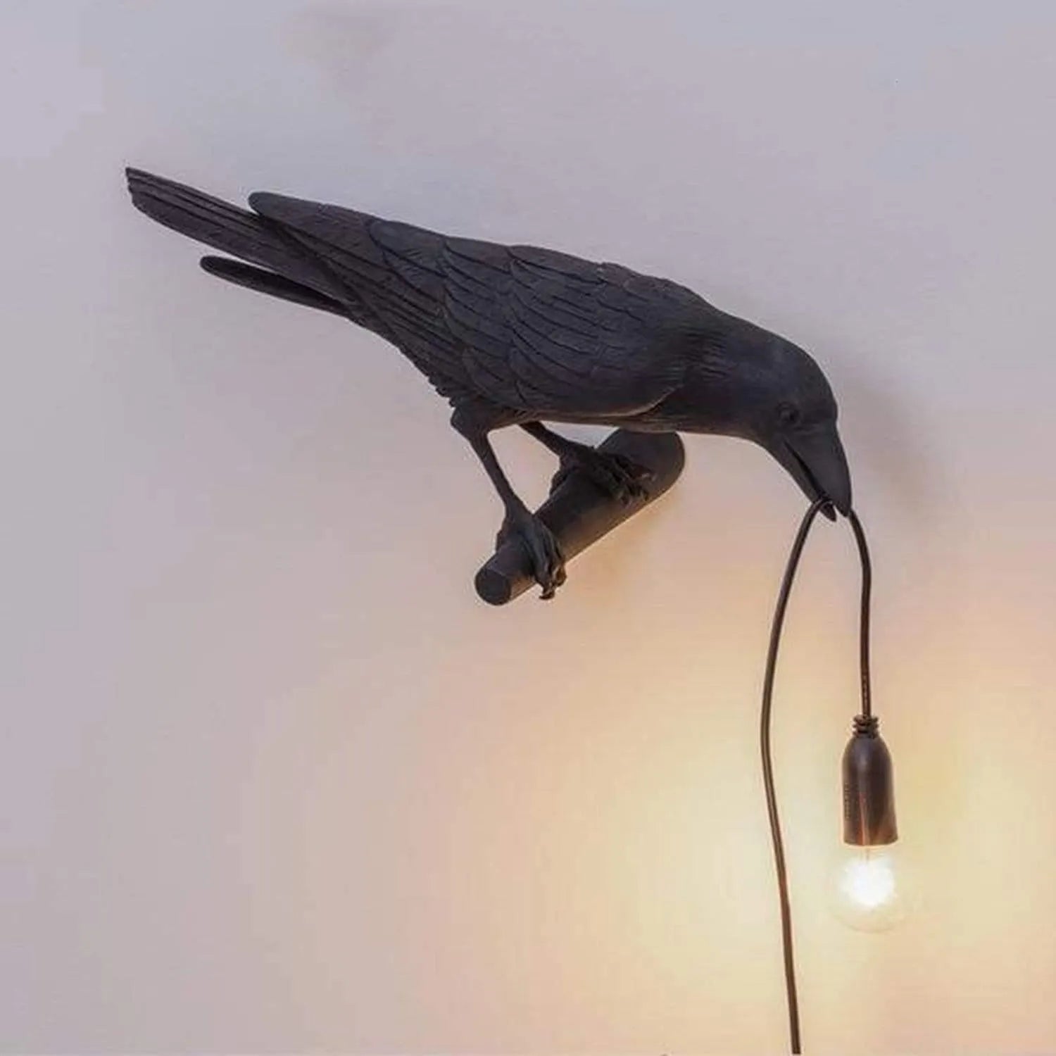 Decorative wall light shaped like a bird with a bulb, on a plain background.