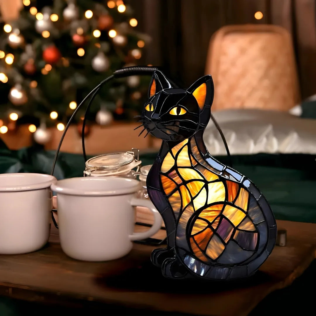 Stained glass cat lamp on a table with mugs and a Christmas tree in the background