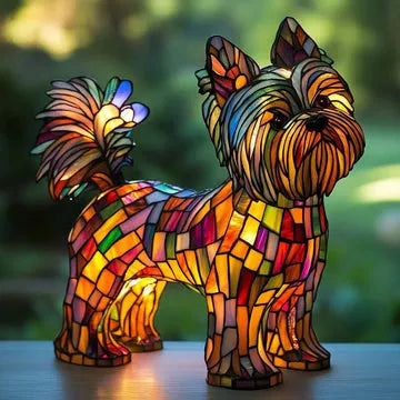 Colorful stained glass dog sculpture on a blurred natural background