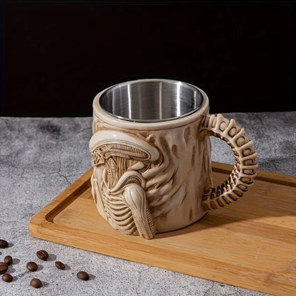 Mug with alien design handle on a wooden board with coffee beans